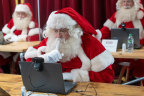 A Santa comes to grips with video technology during a Ministry of Fun training course in London. 