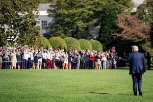 President Donald J. Trump gives a thumbs-up to White House staff and guests as he walks across the South Lawn of the White House Friday, Oct. 23, 2020