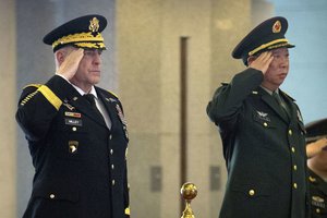 Gen. Mark Milley, left, and China's People's Liberation Army Gen. Li Zuocheng, right, salute during a welcome ceremony at the Bayi Building in Beijing