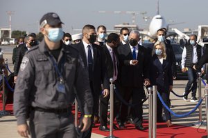 Israeli Prime minister Benjamin Netanyahu, center, walks during a ceremony at the Ben Gurion airport near Tel Aviv, Israel, Thursday, Dec. 3, 2020