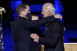 President-elect Joe Biden, right, embraces his son Hunter Biden, left, Saturday, Nov. 7, 2020, in Wilmington, Del.