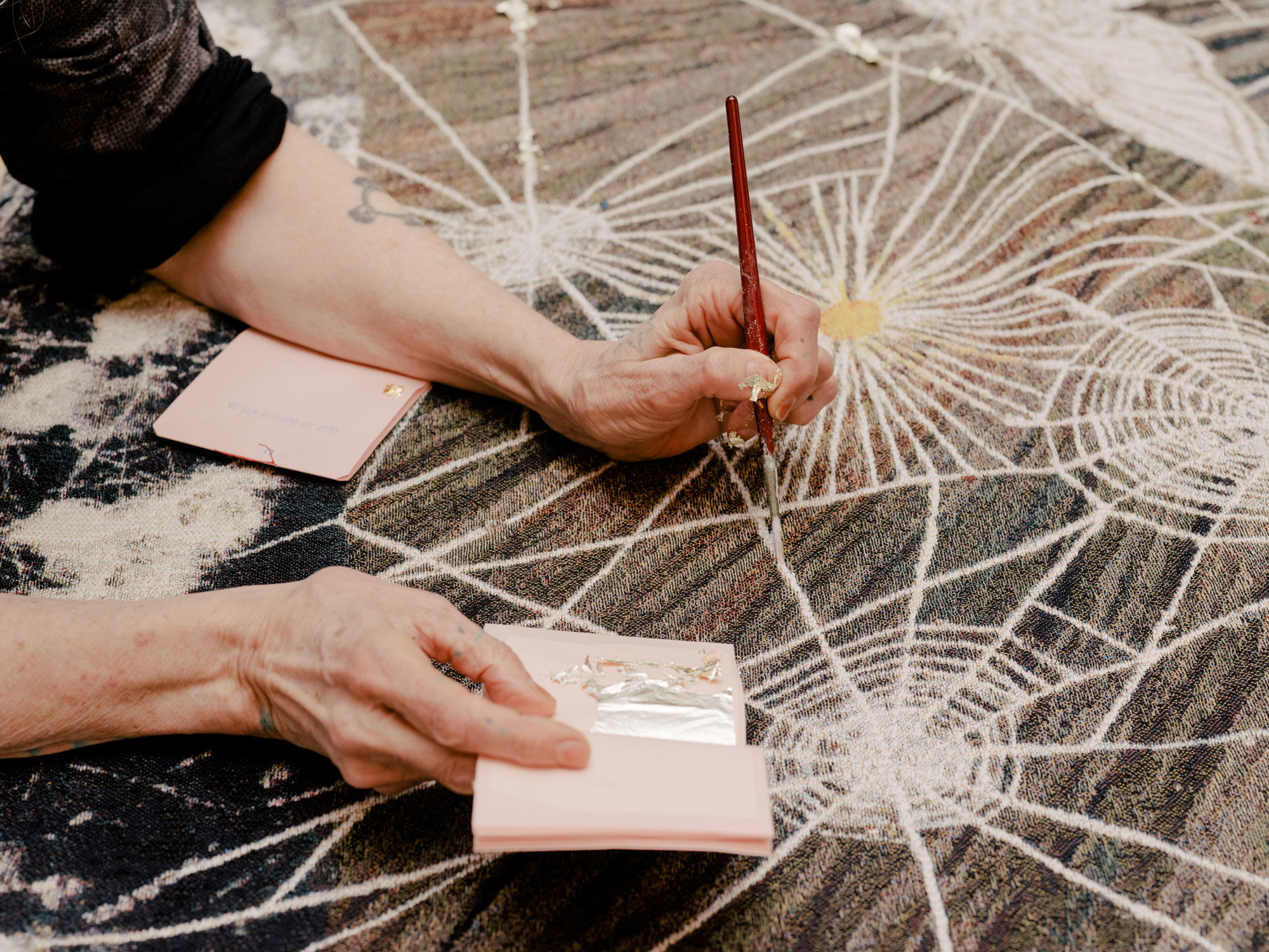 Kiki Smith works on a tapestry in the studio in her East Village home. Photo by Daniel Dorsa for Artsy.