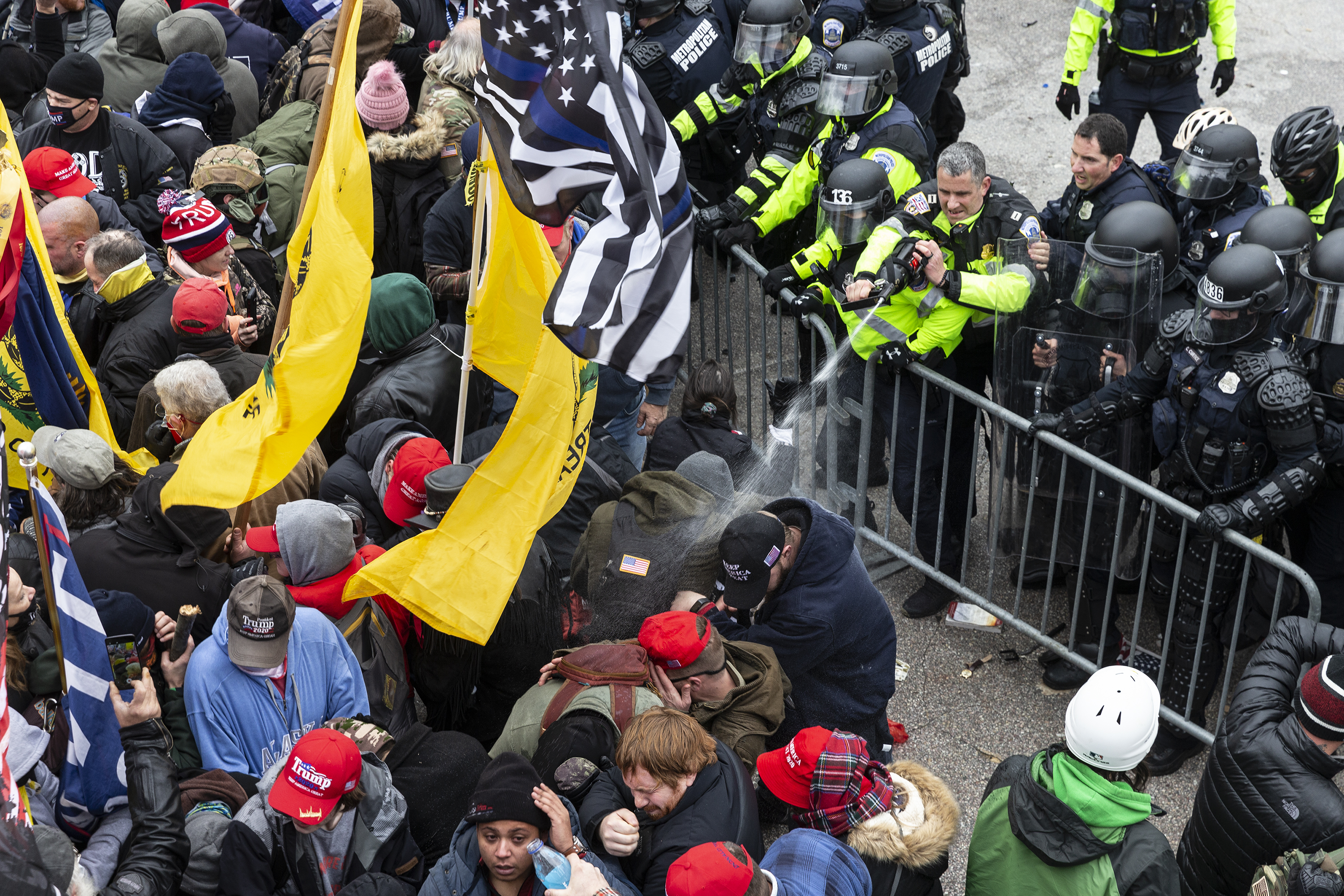 Pro-Trump protesters and police clash on top of the Capitol...