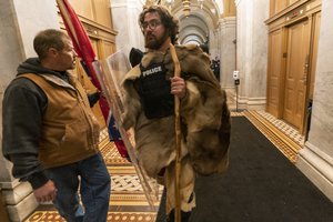 In this Jan. 6, 2021 file photo, insurrectionists loyal to President Donald Trump, including Aaron Mostofsky, right, and Kevin Seefried, left, walk through a hallway of the U.S. Capitol, in Washington.