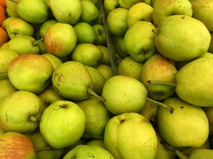 Greenish pear fruits for sale at a market. Taken on December 2017.