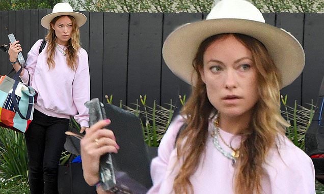 Olivia Wilde has her hands full as she carries bags out of LA home she shared with ex