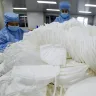 Workers wearing face masks to protect themselves from the coronavirus arrange the face masks at a factory in Handan, Hebei province, China, in January.