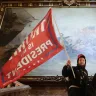 A protester holds a Trump flag inside the US Capitol Building.