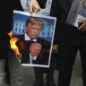 Iranian protesters burned pictures of US President Donald Trump and President-elect Joe Biden after the killing of nuclear scientist Mohsen Fakhrizadeh.