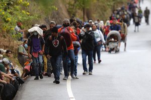 Migrants hoping to reach the U.S. border walk alongside a highway in Chiquimula, Guatemala, Saturday, Jan. 16, 2021