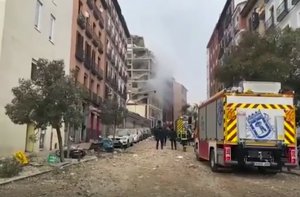 In this image from a video provided by Emergencias Madrid, firefighters go to the scene of an explosion in the center of Madrid, Wednesday, January 20, 2021.