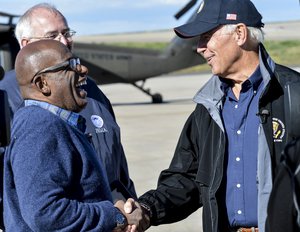 Al Roker, NBC weather forecaster, left, laughs with Vice President Joe Biden Sept. 23, 2013, at Buckley Air Force Base, Colo. Biden and various new affiliates visited Colorado to view the damage and survey recovery efforts after the flooding that killed at least eight people and ravaged at least 14 counties