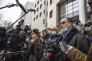 Opposition leader Alexei Navalny's lawyers Vadim Kobzev, right, and Olga Mikhailova, second right, speak to journalists in front of in Moscow, Russia