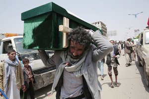 A man carries the coffin of a victim of a Saudi-led airstrike, during a funeral in Saada, Yemen