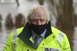 Britain's Prime Minister Boris Johnson during his visit to Withington, Manchester, north west England, Thursday Jan. 21, 2021, as he views flood defences put in place near to the River Mersey for Storm Cristoph which has caused widespread flooding across the UK.