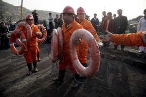 Rescue workers prepare floating aide outside the Wangjialing Coal Mine in Xiangning county in north China's Shanxi province, Sunday, April 4, 2010.