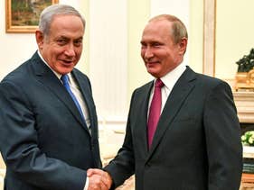 Russian President Vladimir Putin, right, shakes hands with Israeli Prime Minister Benjamin Netanyahu during their meeting at the Kremlin in Moscow, July 11, 2018.