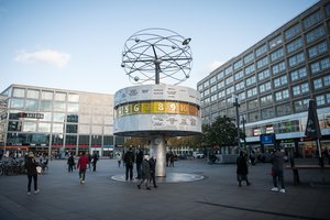 People walk in front of the World Clock during the coronavirus pandemic, Germany