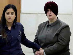 Australian Malka Leifer, right, is brought to a courtroom in Jerusalem, 2018. 