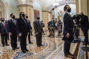 Democratic House impeachment managers stand before entering the Senate Chamber as they deliver to the Senate the article of impeachment alleging incitement of insurrection against former President Donald Trump, in Washington, Monday, Jan. 25, 2021.