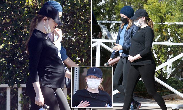 Emma Stone is spotted lovingly cradling her large belly