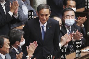 Yoshihide Suga is applauded after being elected as Japan's new prime minister at parliament's lower house in Tokyo, Wednesday, Sept. 16, 2020.