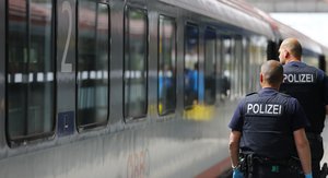 German federal police officers searches for refugees who arrived without documents in a train in Rosenheim, Germany, Tuesday, July 28, 2015.