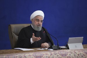 In this photo released by the official website of the office of the Iranian Presidency, President Hassan Rouhani speaks in a cabinet meeting in Tehran, Iran, Wednesday, Dec. 2, 2020.