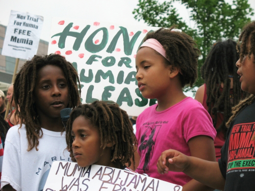 Mumia’s allegiance to MOVE is reciprocated by these MOVE children speaking out for his freedom at last year’s Liberty Bell rally in Philly on the Fourth of July. – Photo: Joe Piette, Workers World