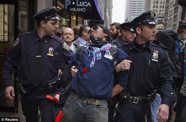 Cuffed: Another Occupy activist is arrested by police during a march through midtown Manhattan