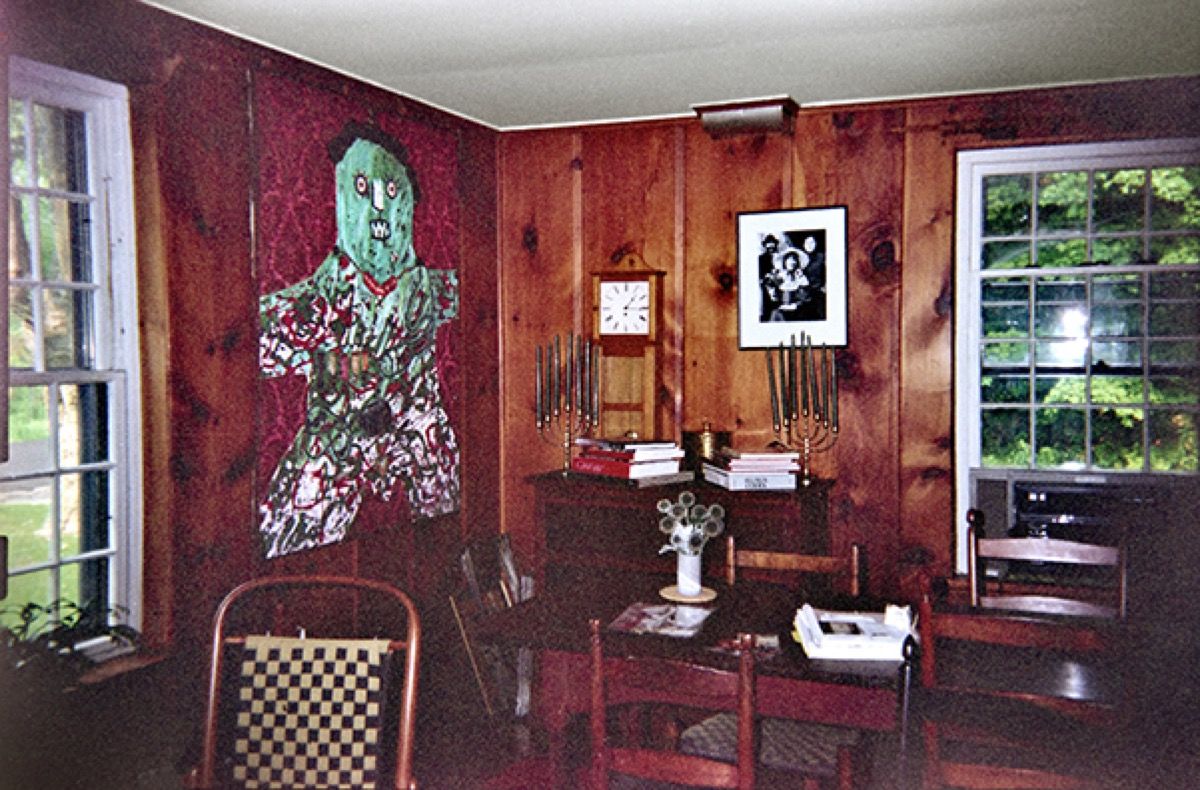 Interior of Jean Brown’s Shaker Seed House, Tyringham, Massachusetts, early 1990s, showing Enrico Baj’s painting General Schwarz, 1961; a photograph of George Maciunas, Yoko Ono, and John Lennon; and two menorahs. Courtesy of Marcia Reed, Yoko Ono, and the Jean Brown Foundation. 