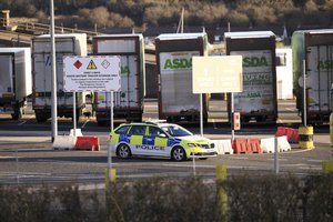 Police conduct a security sweep at the P&O ferry terminal in the port at Larne on the north coast of Northern Ireland, Friday, Jan. 1, 2021