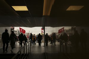 People walk in an underpass of the Galata Bridge over the Golden Horn, hours before a two-day weekend lockdown, in Istanbul, Friday, Jan. 29, 2021