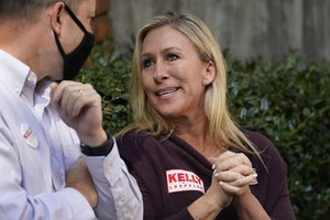 Republican candidate for Georgia's 14th congressional seat Marjorie Taylor Greene speaks to Georgia attorney general Chris Carr during a campaign rally for Republican Sen. Kelly Loeffler Saturday, Oct. 31, 2020, in Roswell