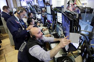 Traders with Livermore Trading Group, including Vincent Napolitano, foreground, work in their booth on the floor of the New York Stock Exchange, Monday