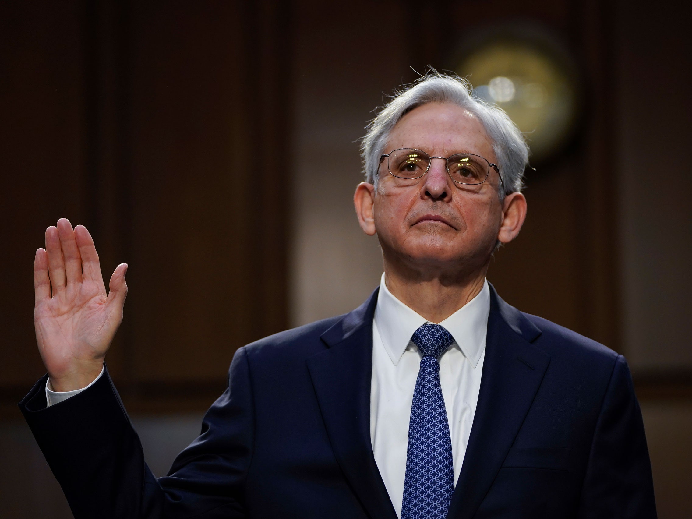 Merrick Garland raising his hand