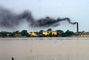 File - A factory on the river Hooghly in the industrial town of Rishra, India, spews black smoke from a chimney. More than 5 million people die annually from air pollution, with the majority of deaths in China and India.