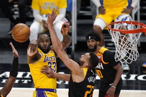 Los Angeles Lakers forward LeBron James (23) passes the ball as Utah Jazz center Rudy Gobert (27) defends in the first half during an NBA basketball game Wednesday, Feb. 24, 2021, in Salt Lake City