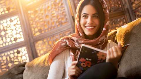 Woman smiling as she reads a book