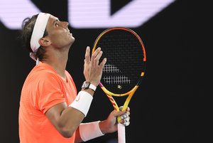 Spain's Rafael Nadal reacts after losing a point against Greece's Stefanos Tsitsipas during their quarterfinal match at the Australian Open tennis championship in Melbourne, Australia, Wednesday, Feb. 17, 2021