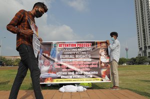 Members of Sri Lanka Thawheed Jamaath, a Muslim organization, display a banner demanding burial rights for Muslims who die of COVID-19, in Colombo, Sri Lanka, Wednesday, Dec. 16, 2020.