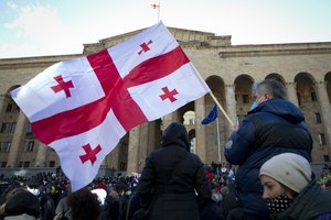 Georgian opposition supporters attend a rally following the detention of the United National Movement party leader Nika Melia, Tbilisi, Georgia, Tuesday, Feb. 23, 2021.