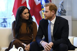 Britain's Prince Harry and Meghan, Duchess of Sussex gesture during their visit to Canada House in thanks for the warm Canadian hospitality and support they received during their recent stay in Canada, in London, Tuesday, Jan. 7, 2020.