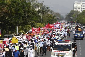 Thousands of students march along main road during a street march in Mandalay, Myanmar, Friday, Feb. 26, 2021. Tensions escalated Thursday on the streets of Yangon, Myanmar's biggest city, as supporters of Myanmar's junta attacked people protesting the military government that took power in a coup, using slingshots, iron rods and knives to injure several of the demonstrators. (AP Photo)