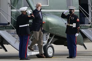 President Joe Biden walks off of Marine One to head towards Air Force One at Andrews Air Force Base, Md., Friday, Feb. 26, 2021.