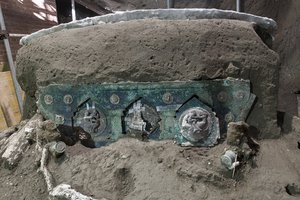 A view of a chariot, with its iron elements, bronze decorations and mineralized wooden remains, that was found in Civita Giuliana, north of Pompeii