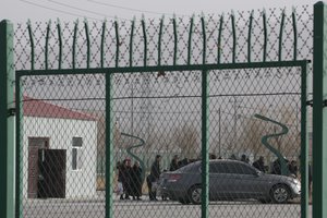 In this Dec. 3, 2018, file photo, people line up at the Artux City Vocational Skills Education Training Service Center at the Kunshan Industrial Park in Artux in western China's Xinjiang region. Human Rights Watch claims that they have been used to indoctrinate Uighurs.