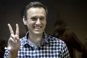 Russian opposition leader Alexei Navalny stands in a cage in the Babuskinsky District Court in Moscow, Russia