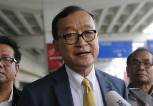 Cambodia's exiled opposition leader Sam Rainsy talks to the media upon arrival at Soekarno-Hatta International Airport in Tangerang, Indonesia, Thursday, Nov. 14, 2019.