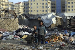 FILE - in this Monday, Jan. 18, 2021, Internally displaced boys play outside their temporary home in the city of Kabul, Afghanistan. (AP Photo/Rahmat Gul, File)